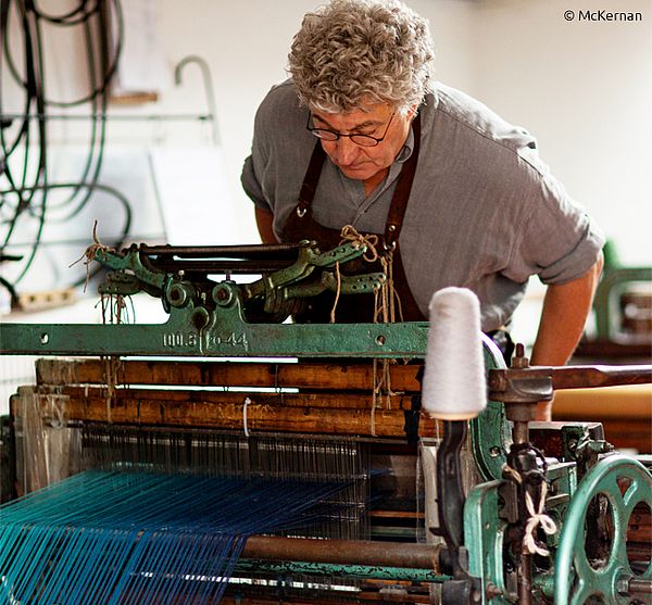 Eugene McKernan prüft die Arbeit der restaurierten Strickmaschine. McKernan-Gründer Eugene prüft die Arbeit der viktorianischen Strickmaschine.